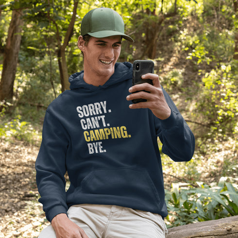 Introducing the ultimate escape gear for all the weekend warriors, the "Sorry. Can't. Camping. Bye." hoodie! This isn't just any ordinary piece of clothing; it's your ticket to avoiding all unwanted plans, chores, and responsibilities.